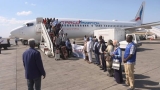وصول الفوج الثاني للاجئين السودانيين في أوغندا إلى مطار بورتسودان